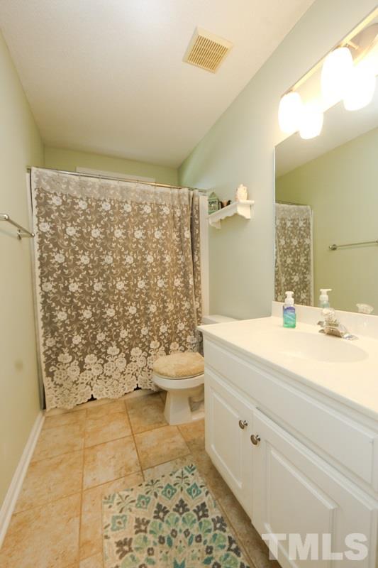 122 Forest Lane Garner, NC 27529 - Photo 12 of 18 a bathroom with a sink a toilet and shower