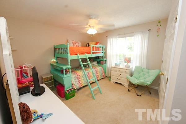 122 Forest Lane Garner, NC 27529 - Photo 13 of 18 a bedroom with furniture and a chair