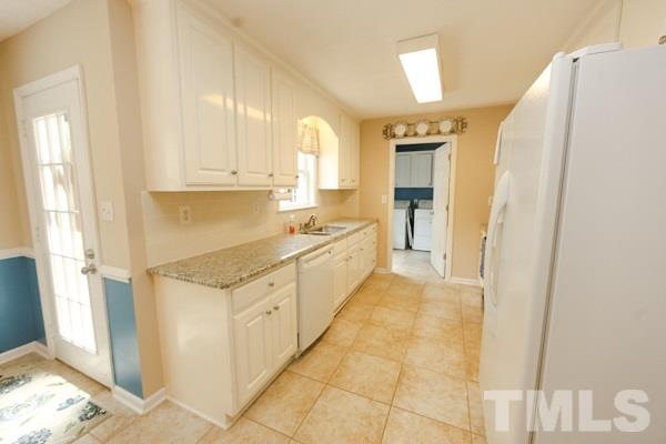 122 Forest Lane Garner, NC 27529 - Photo 6 of 18 a kitchen with granite countertop white cabinets and white appliances