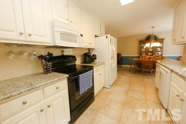 122 Forest Lane Garner, NC 27529 - Photo 7 of 18 a kitchen with granite countertop a sink stove and cabinets