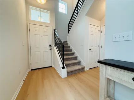 a view of entryway with wooden floor and stairs