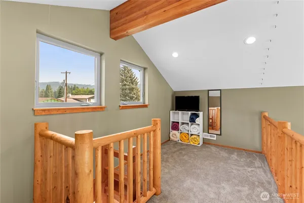 a view of a livingroom with furniture and a flat screen tv