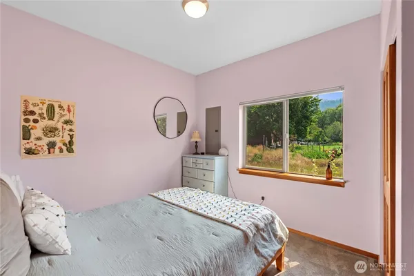 a bedroom with a bed and a large window