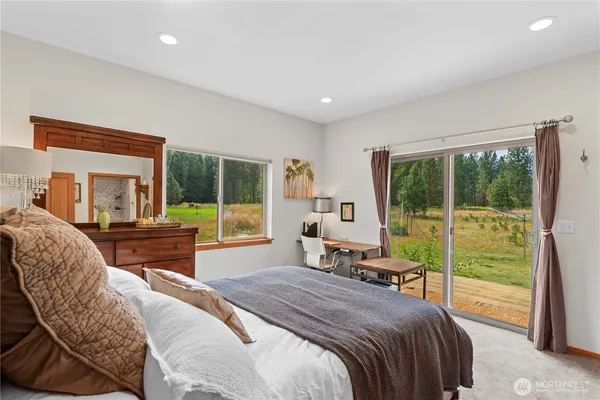 a bedroom with a bed and a large window