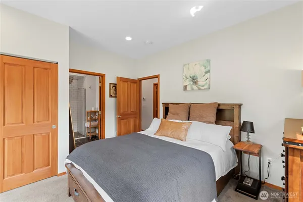 a bedroom with a large bed and a chandelier
