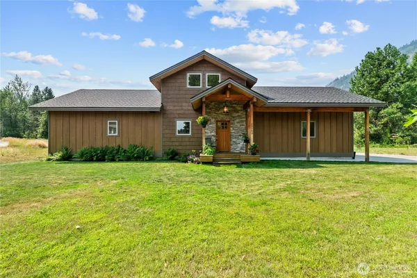 a front view of a house with a garden