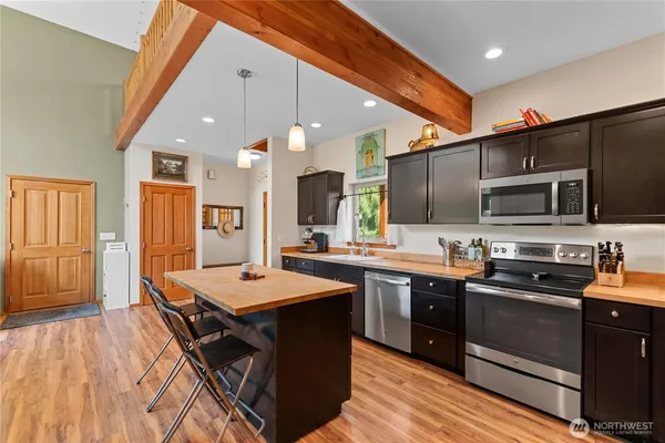 a kitchen with stainless steel appliances a sink stove and refrigerator