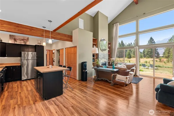a living room with fireplace furniture and a large window
