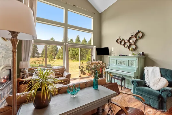 a living room with furniture and a floor to ceiling window