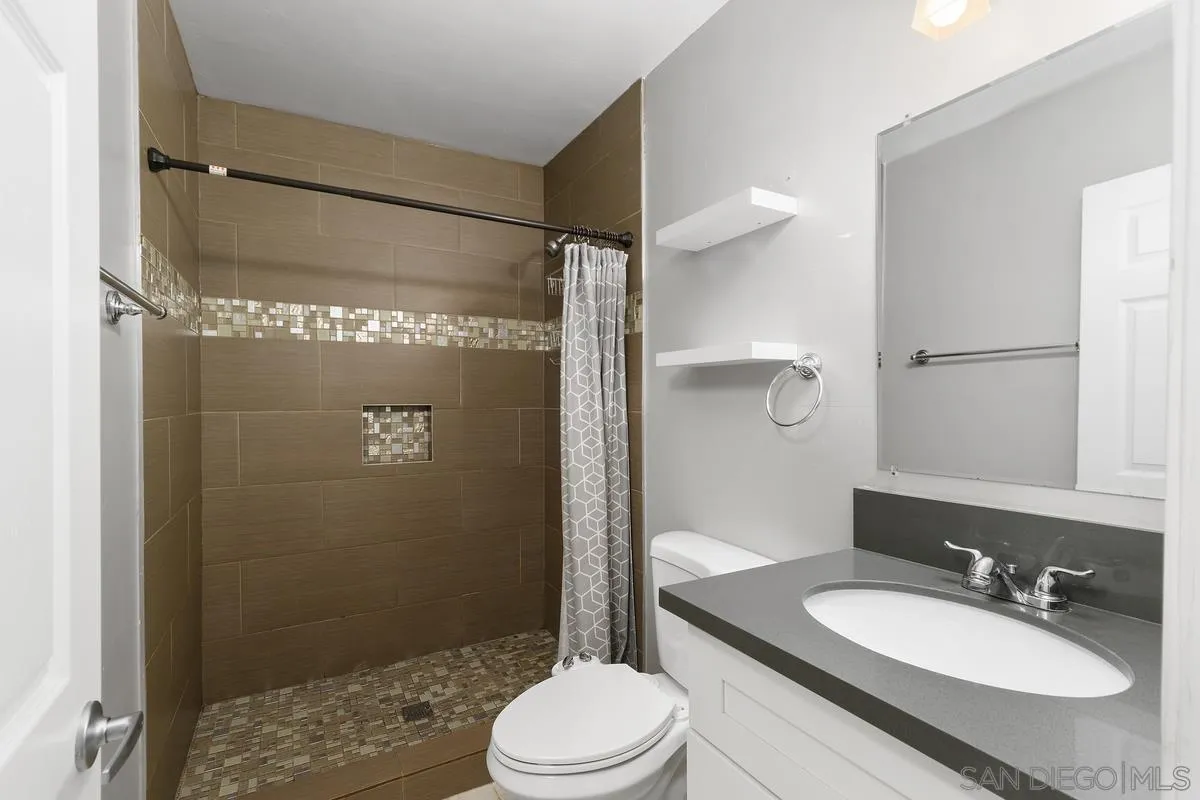 180 5th Avenue Chula Vista, CA 91910 - Photo 16 of 18 a bathroom with a sink toilet and shower