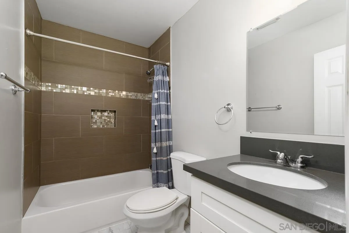 180 5th Avenue Chula Vista, CA 91910 - Photo 18 of 18 a bathroom with a granite countertop sink toilet mirror vanity and bathtub