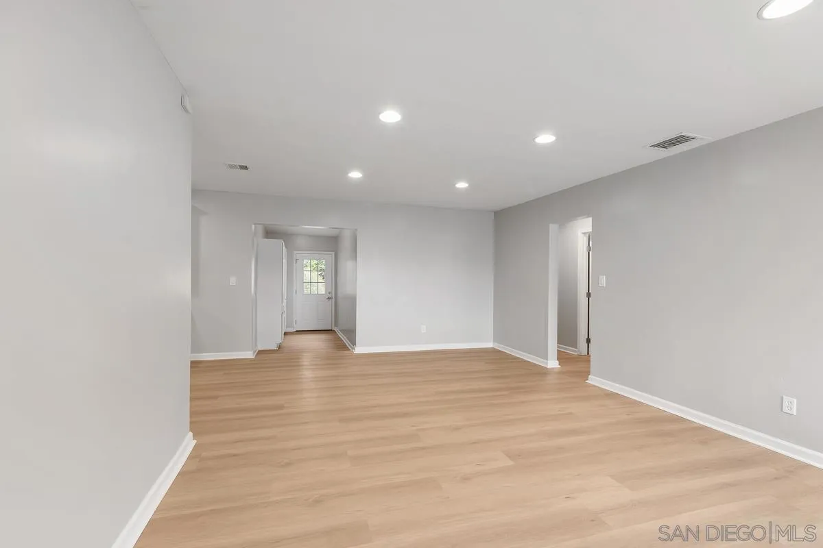 180 5th Avenue Chula Vista, CA 91910 - Photo 4 of 18 a view of an empty room with window and wooden floor