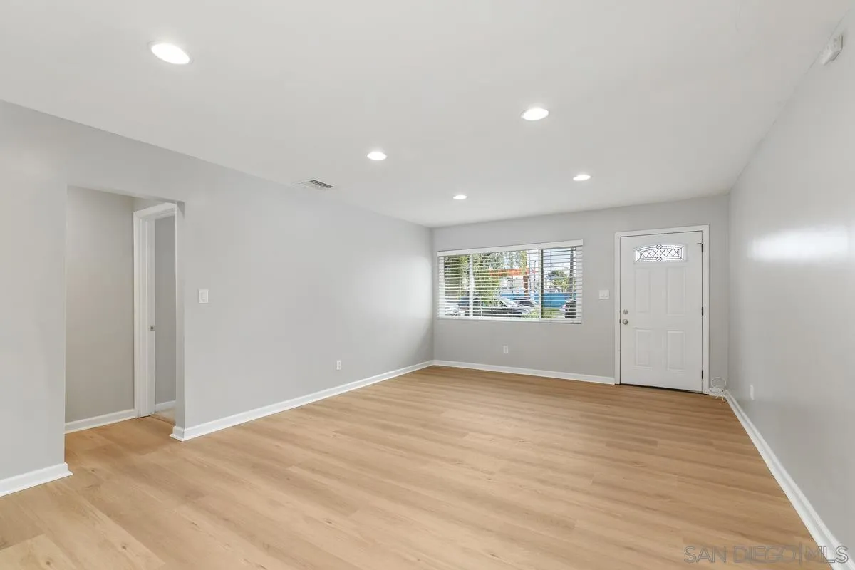 180 5th Avenue Chula Vista, CA 91910 - Photo 5 of 18 a view of an empty room with wooden floor and a window