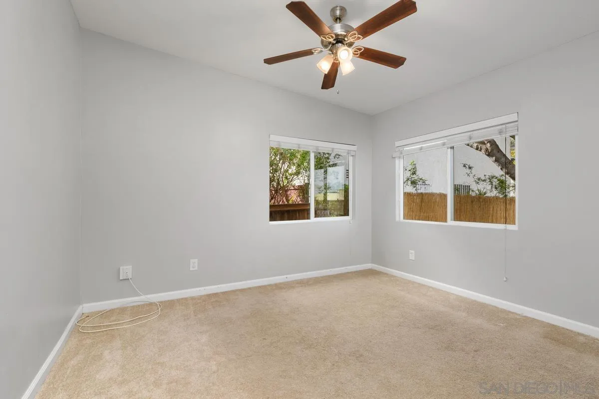 180 5th Avenue Chula Vista, CA 91910 - Photo 10 of 18 an empty room with window and ceiling fan