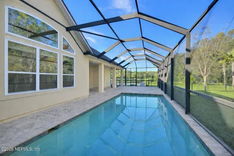 a view of a backyard with a swimming pool