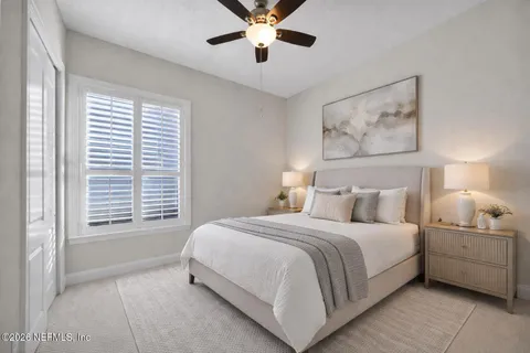 a bedroom with a large bed and a chandelier