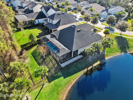 an aerial view of residential houses with outdoor space and swimming pool