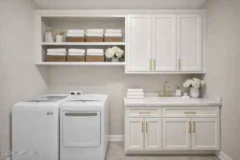 a view of cabinets with washer and dryer