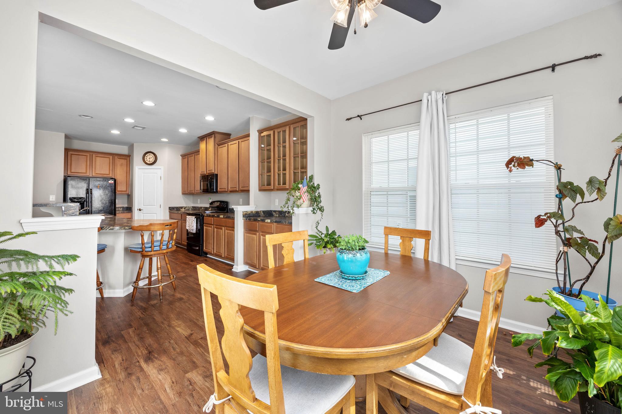 191 Bobbys Branch Road Millsboro, DE 19966 - Photo 13 of 40 a dining room with stainless steel appliances kitchen island granite countertop a dining table and chairs with wooden floor