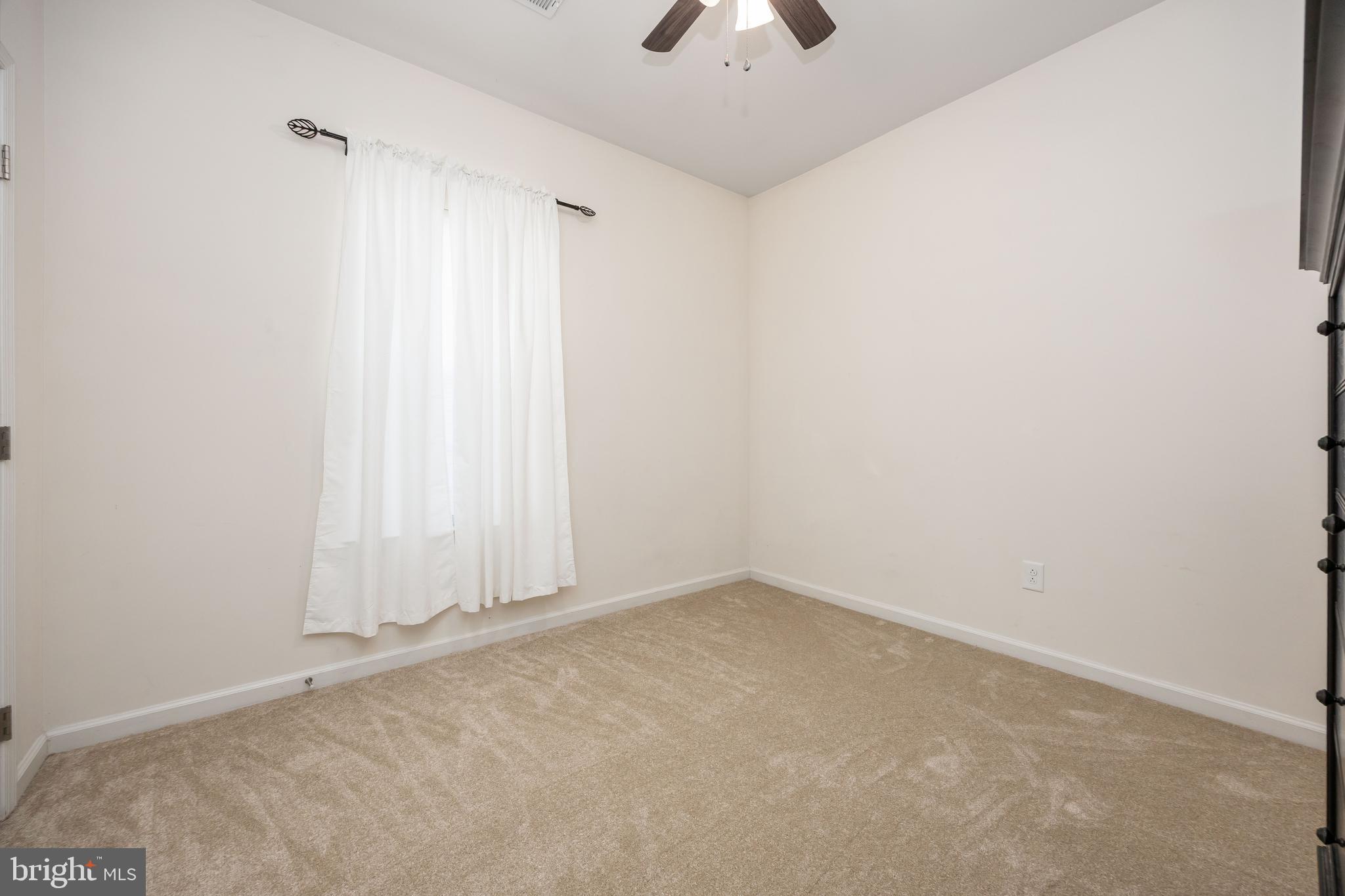191 Bobbys Branch Road Millsboro, DE 19966 - Photo 27 of 40 an empty room with a ceiling fan and window