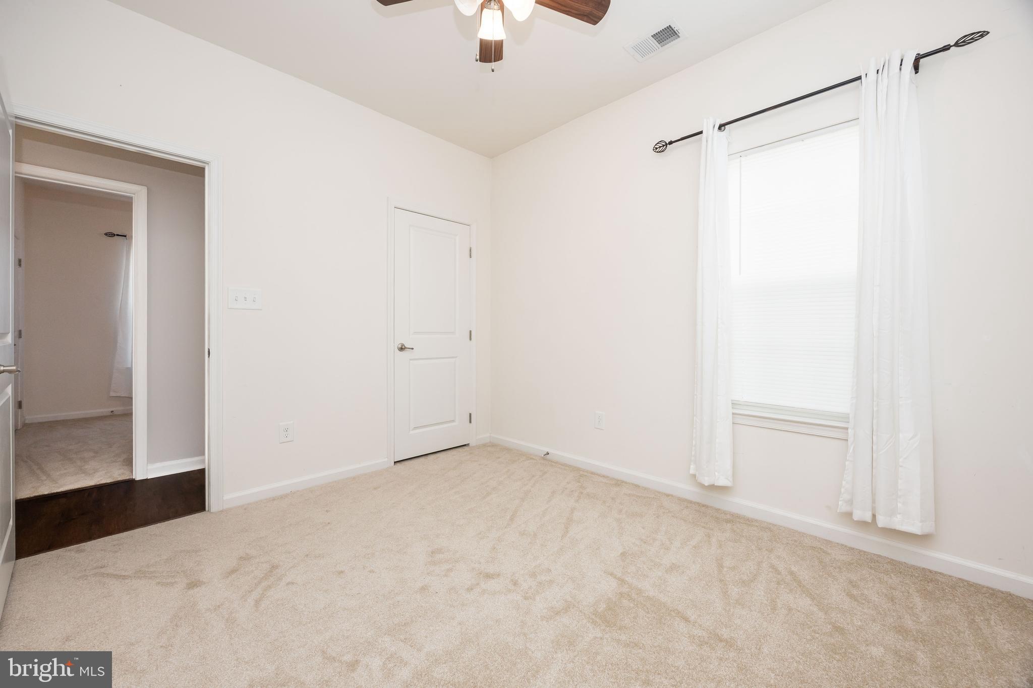 191 Bobbys Branch Road Millsboro, DE 19966 - Photo 31 of 40 an empty room with a ceiling fan and a window