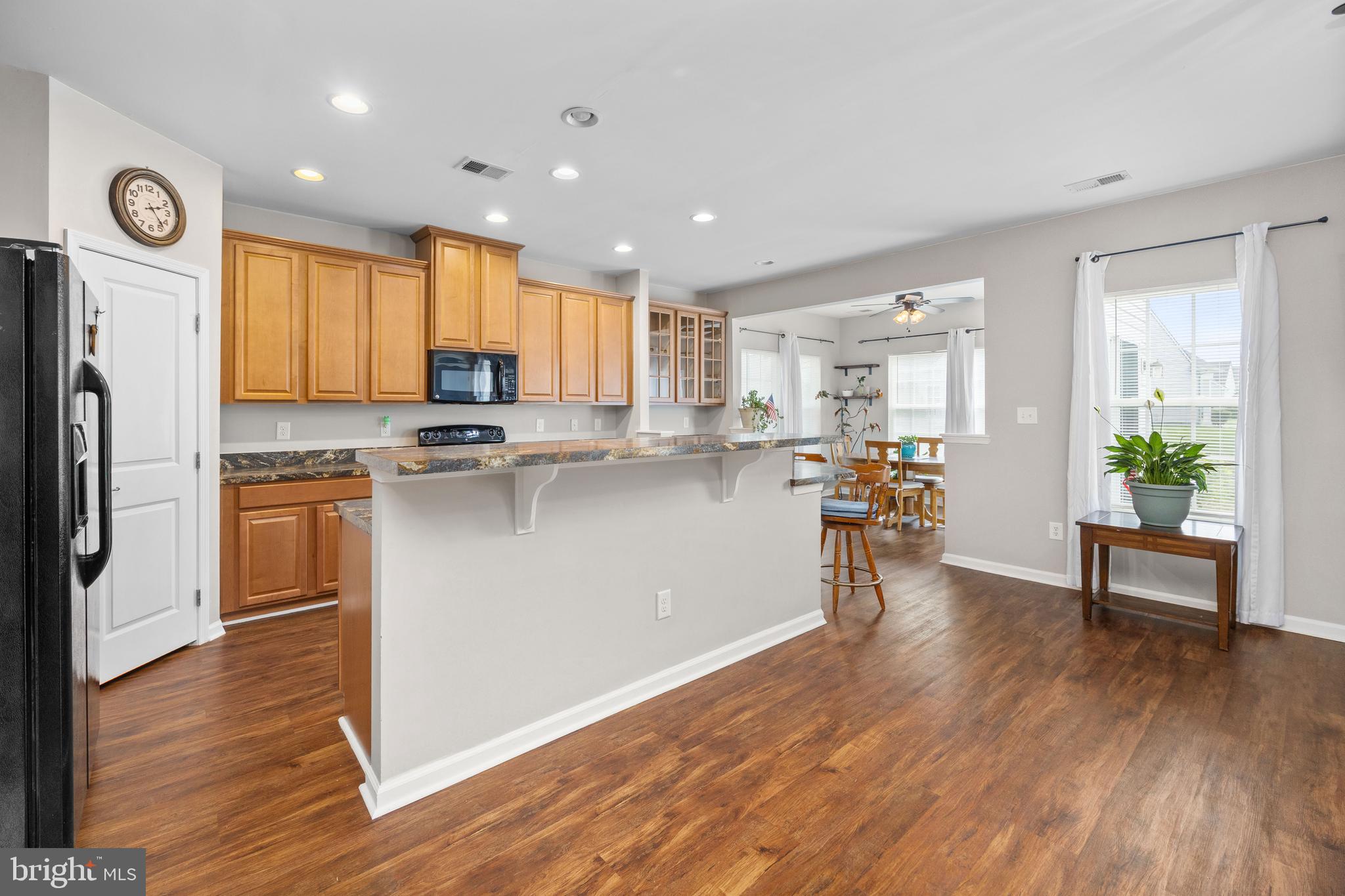 191 Bobbys Branch Road Millsboro, DE 19966 - Photo 5 of 40 a kitchen with a refrigerator a stove top oven and white cabinets
