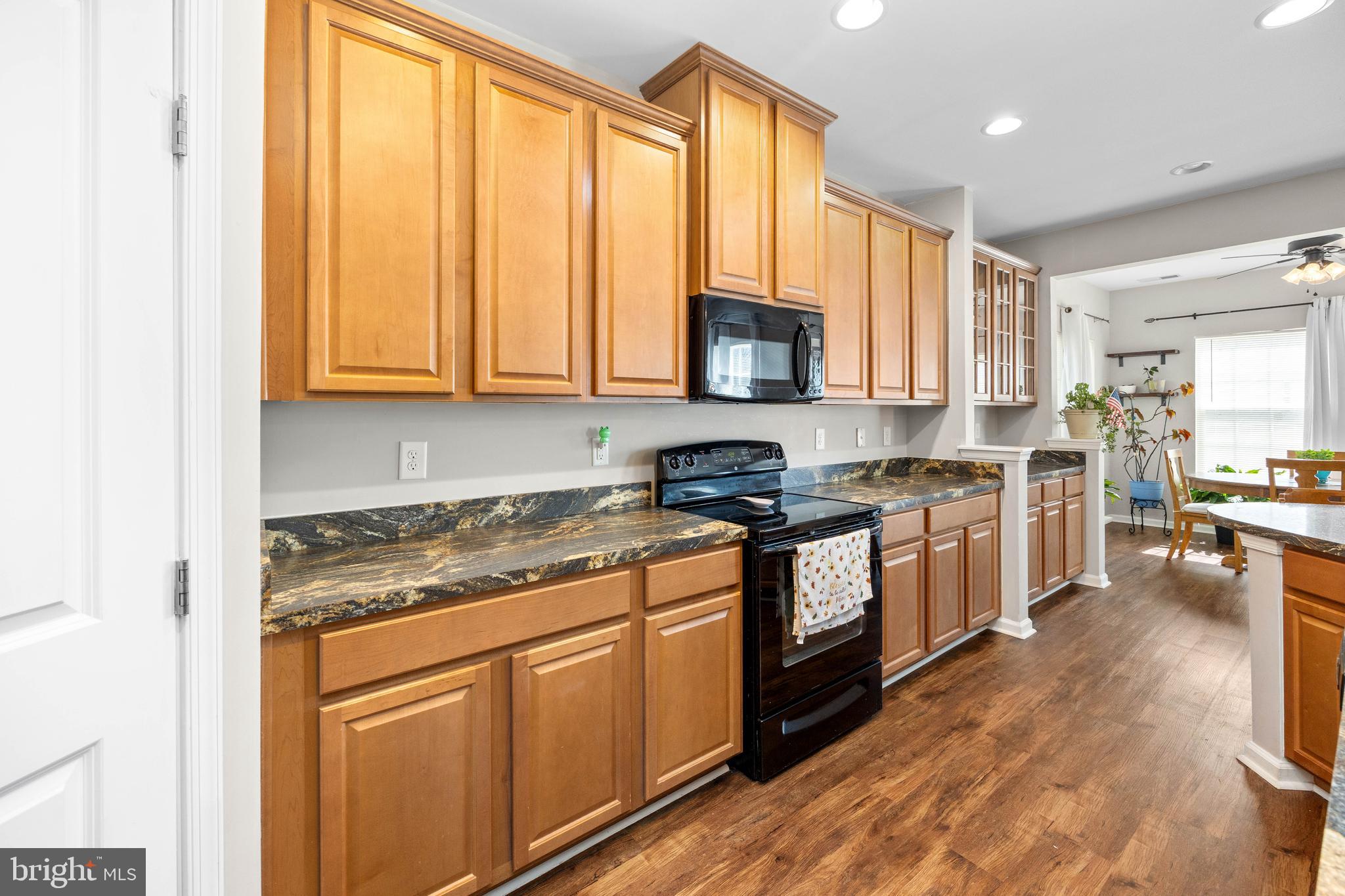 191 Bobbys Branch Road Millsboro, DE 19966 - Photo 9 of 40 a kitchen with stainless steel appliances granite countertop a stove a sink and a microwave