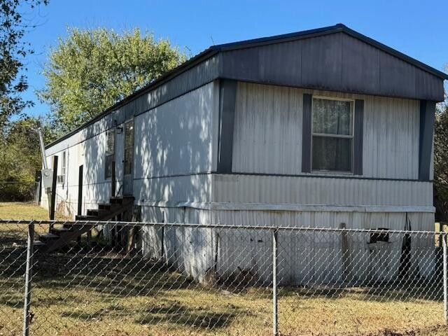 a view of a wooden house with a wooden fence