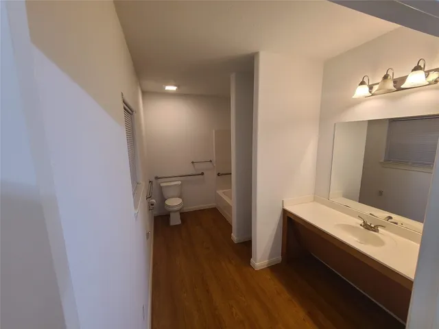 a view of hallway with wooden floor