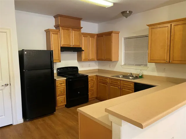 a kitchen with a refrigerator and a sink