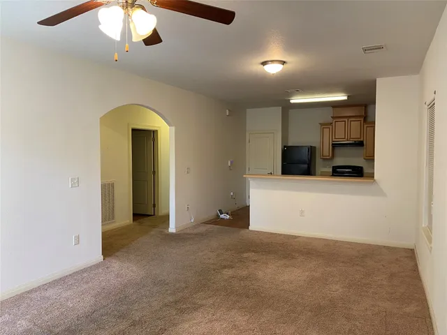 en empty room with garage and ceiling fan