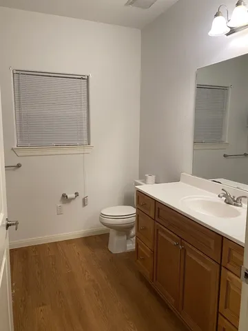 a bathroom with a toilet sink and mirror
