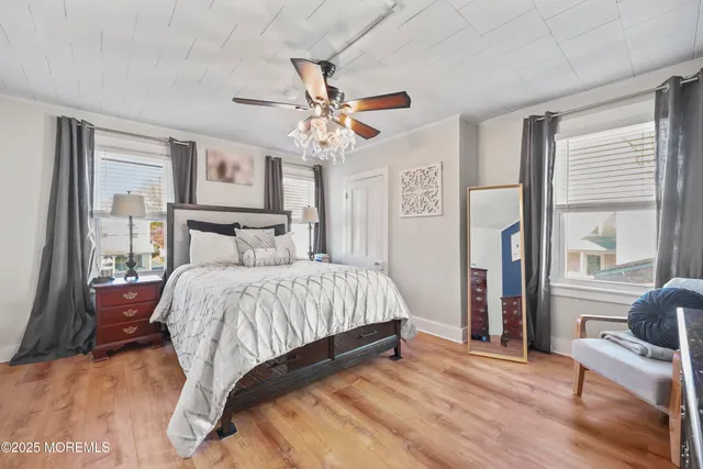 a bedroom with a large bed and a chandelier