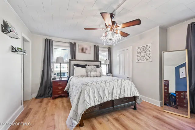 a bedroom with a bed and a chandelier