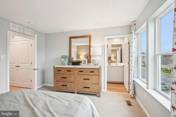 a room with a bed and a mirror