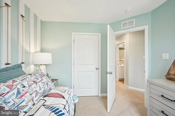 a bedroom with a bed and a lamp