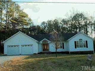 a house that has a tree in front of it