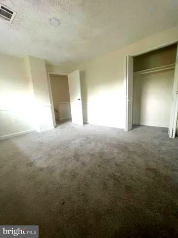 an empty room with a empty space and windows