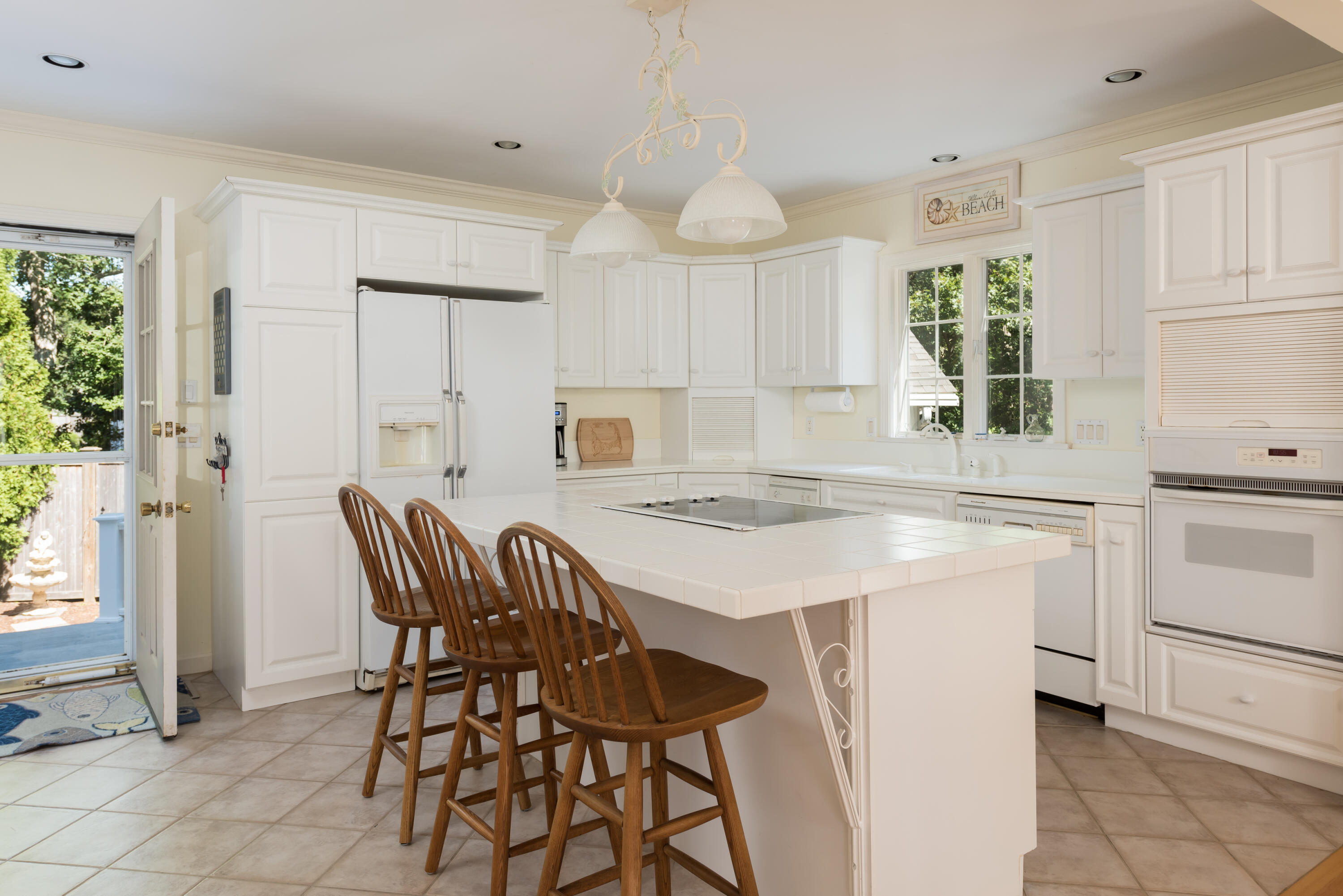 280 Lower County Road Harwich Port, MA 02646 - Photo 12 of 34 a kitchen with a stove a table and chairs