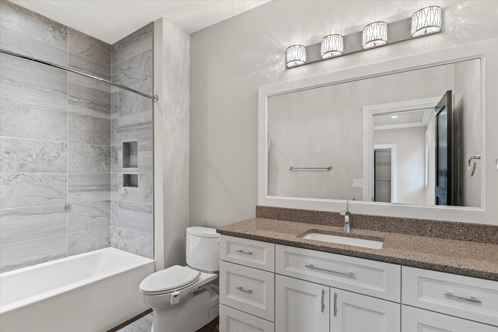 1410 East White Oak Road Mahomet, IL 61853 - Photo 102 of 140 a bathroom with a granite countertop sink a toilet and bathtub