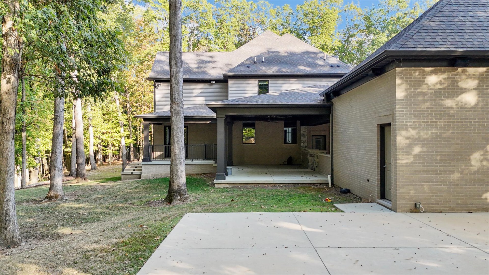 1410 East White Oak Road Mahomet, IL 61853 - Photo 21 of 140 a front view of a house with a garden and trees