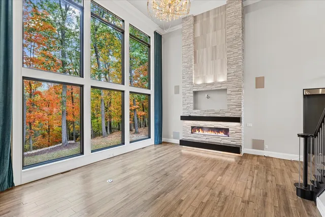 a large bedroom with a large window and a glass door shower