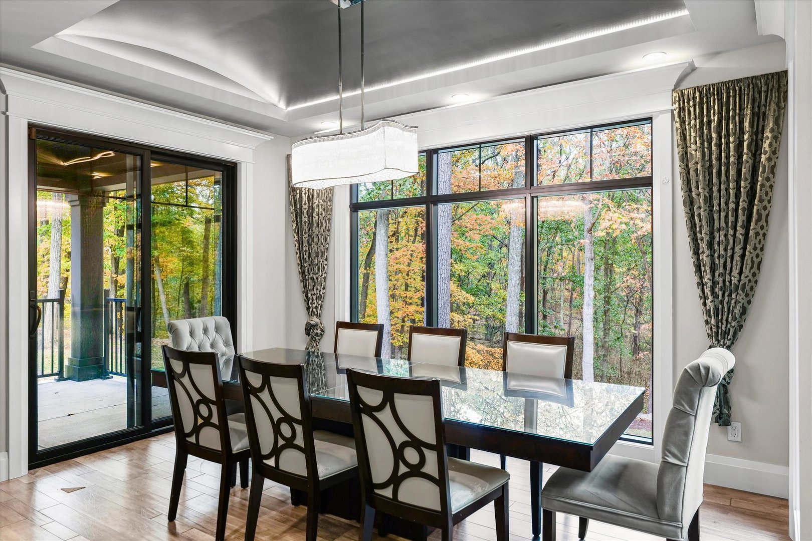 1410 East White Oak Road Mahomet, IL 61853 - Photo 65 of 140 a view of a dining room with furniture large windows and wooden floor