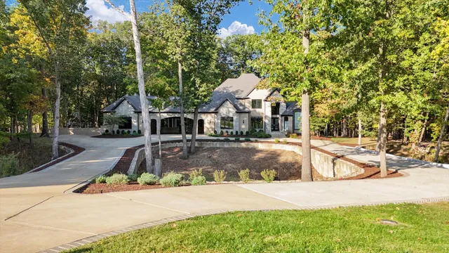 a view of a white house with a swimming pool and sitting area