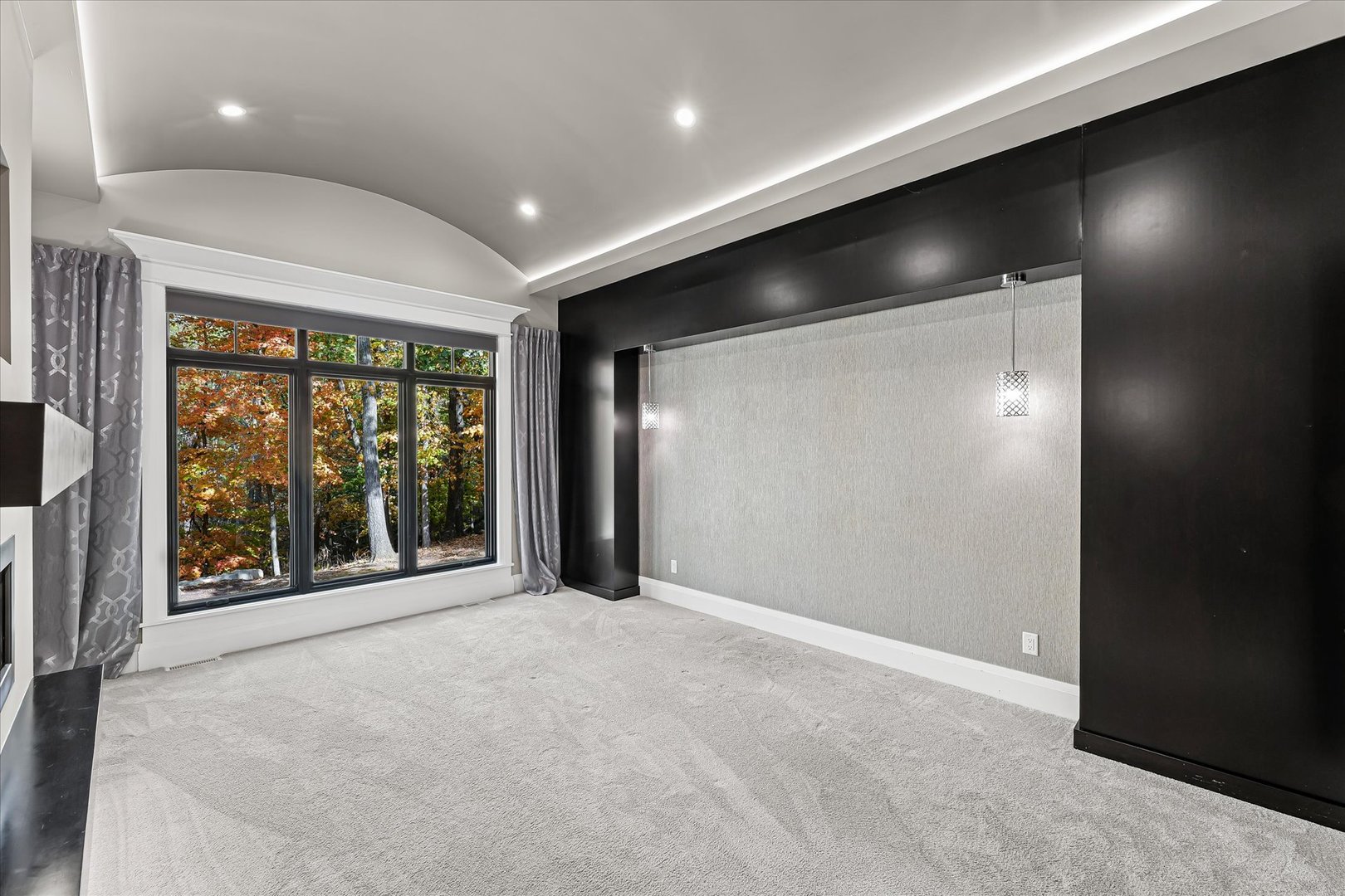 1410 East White Oak Road Mahomet, IL 61853 - Photo 73 of 140 en empty room with large windows and a projector