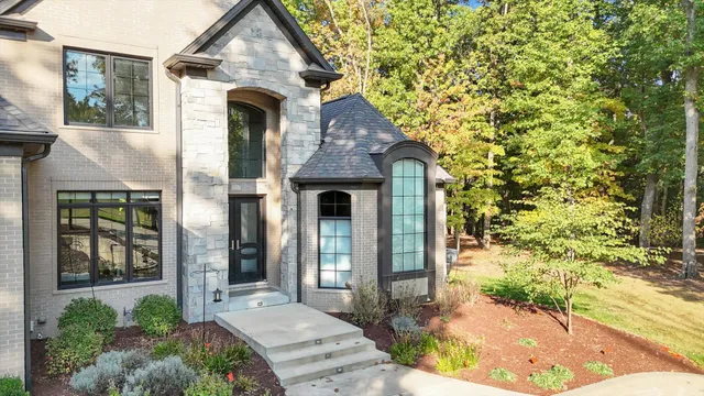 a view of a house with a backyard and a tree