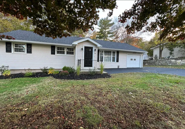 a front view of a house with a garden