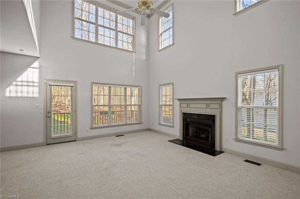 166 Old March Road Advance, NC 27006 - Photo 6 of 32 This amazing den provides plenty of space to relax and enjoy the view. With the two-story windows that look out to the wooded backyard, making it the perfect spot to enjoy the natural beauty of your surroundings.