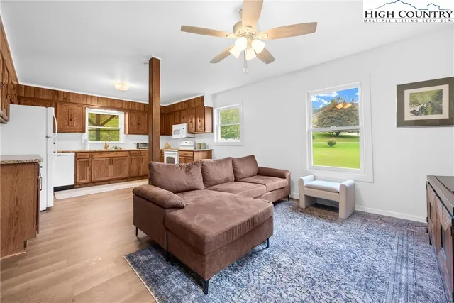 a living room with furniture and a wooden floor
