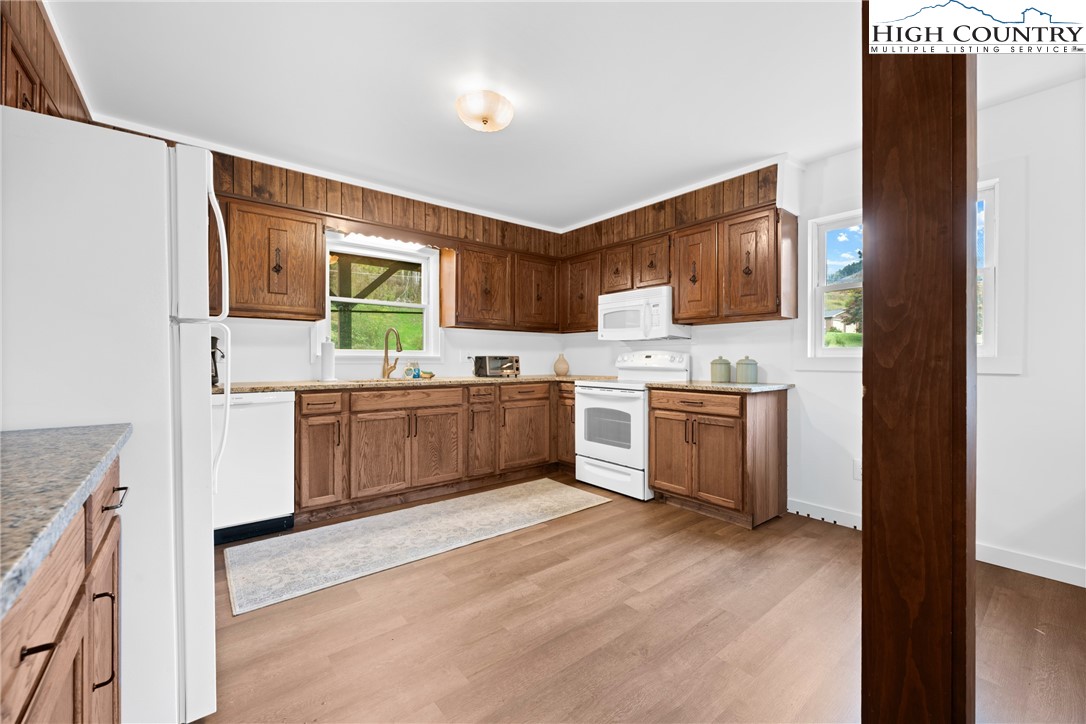 1044 Highway 321 Vilas, NC 28692 - Photo 19 of 47 a kitchen with stainless steel appliances a sink and a refrigerator